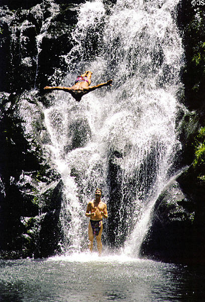 Diving from waterfall at Waimea Valley Adventure Park. Oahu, HI.
