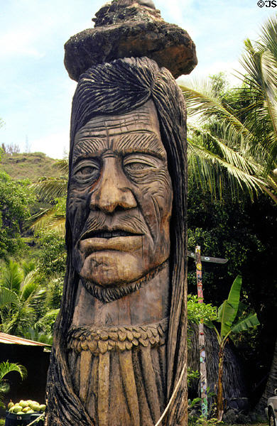 Wood carving of Maui Pohaku at roadside on northern coast of Oahu. Oahu, HI.