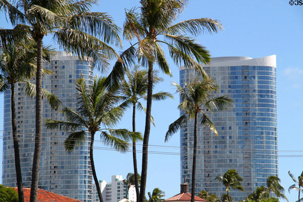 Moana Pacific Towers through palm trees. Honolulu, HI.