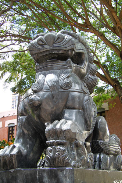 Chinese stone female lion with cub in Dr. Sun Yat-sen Memorial Park at entrance to Chinatown area of Honolulu. Honolulu, HI.