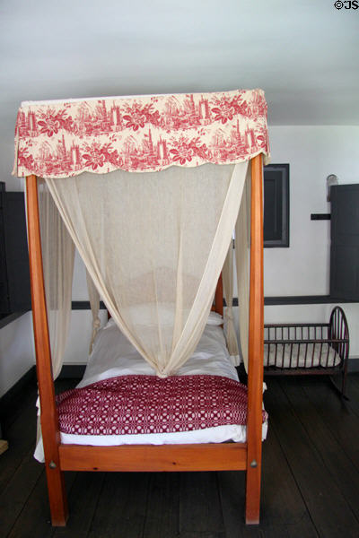 Upstairs bedroom with canopy bed & insect netting in Oldest Frame House of Mission House Museum. Honolulu, HI.