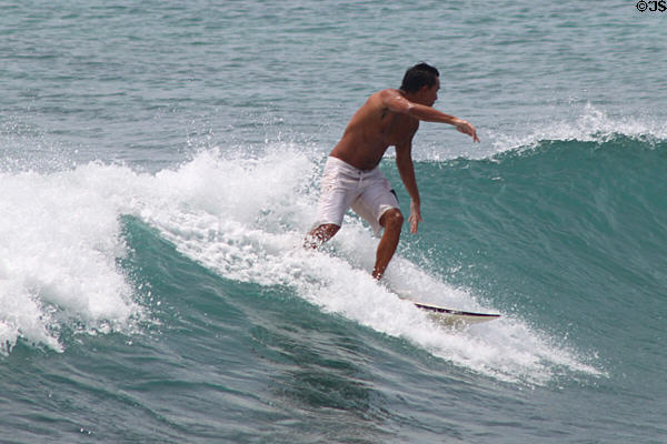 Wave riding surfers off Waikiki Beach. Waikiki, HI.