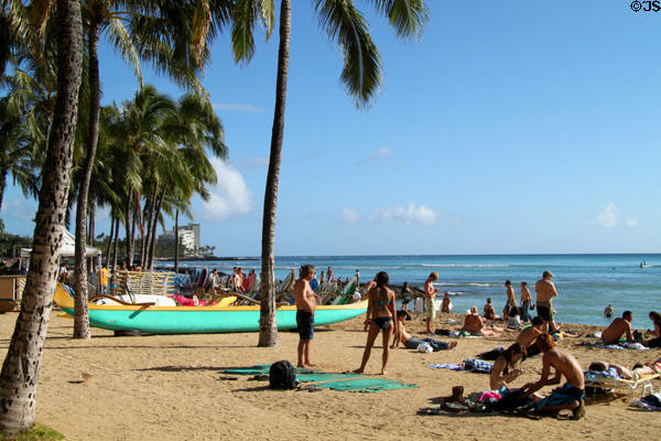 Sun bathers along beach in Waikiki. Waikiki, HI.
