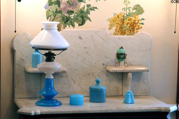 Blue glass vanity objects plus blue oil lamp with white glass shade at Dodge House. Council Bluffs, IA.