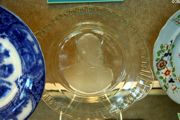 Pressed glass memorial plate to President Garfield made by Iowa City Flint Glass Mfg. at Historical Museum of Iowa. Des Moines, IA.