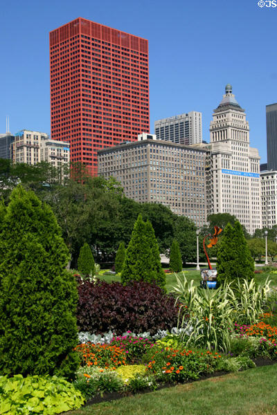 Red CNA Plaza, McCormick, & Metropolitan buildings over gardens of Grant Park. Chicago, IL.