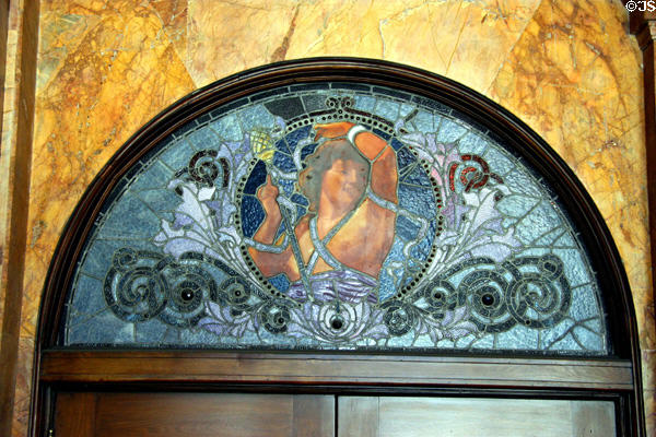 Stained glass window of woman with torch over entrance of Auditorium Building. Chicago, IL.