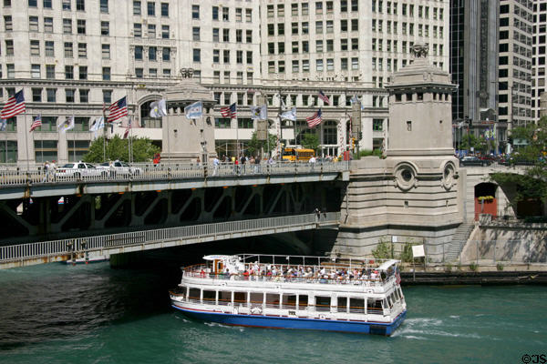 Tour boat passes under Michigan Avenue Bridge (1920) over Chicago River. Chicago, IL. Architect: Edward Burnnett.