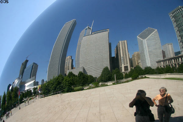 Photographer & friend take self portrait with city reflected off Cloud Gate sculpture in Millennium Park. Chicago, IL.