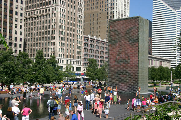 Crown Fountain by Jaume Plensa has two 50-foot glass block towers at ends of wading pool upon which are projected faces of Chicago citizens in Millennium Park. Chicago, IL.