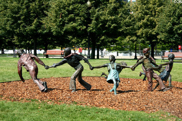 Sculpture group of children playing snap the whip in Navy Pier Park. Chicago, IL.