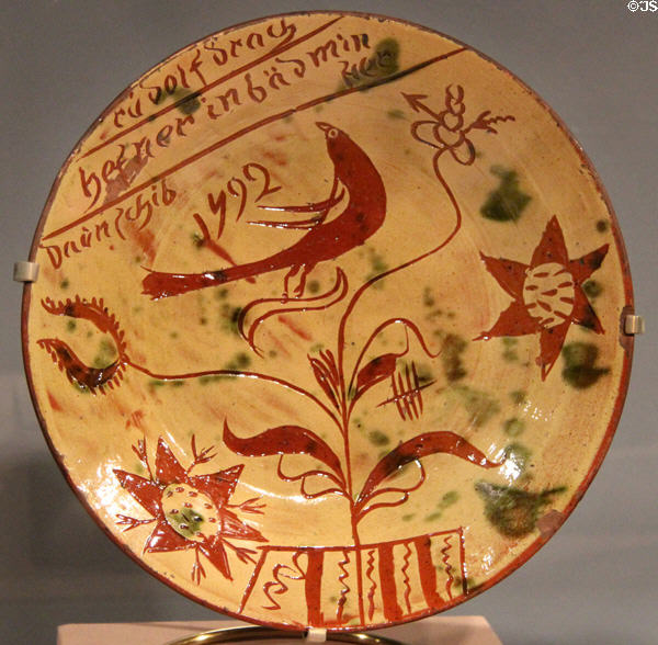 Redware plate painted with bird in tree (1792) from Southeastern PA at Art Institute of Chicago. Chicago, IL.