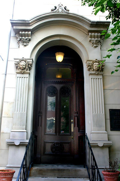 Doorway with sculpted faces (28 W 5th St.). Covington, KY.