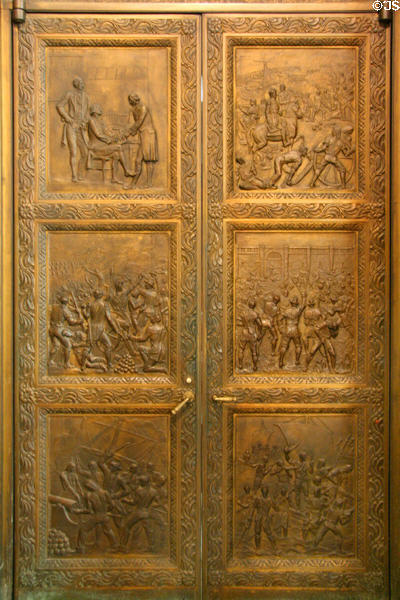 Bronze doors weighing one ton each showing history of Louisiana at entrance to House Chamber at Louisiana State Capitol. Baton Rouge, LA.
