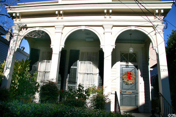 Shotgun house with arched porch columns (2309 Coliseum St.) in Garden District. New Orleans, LA.