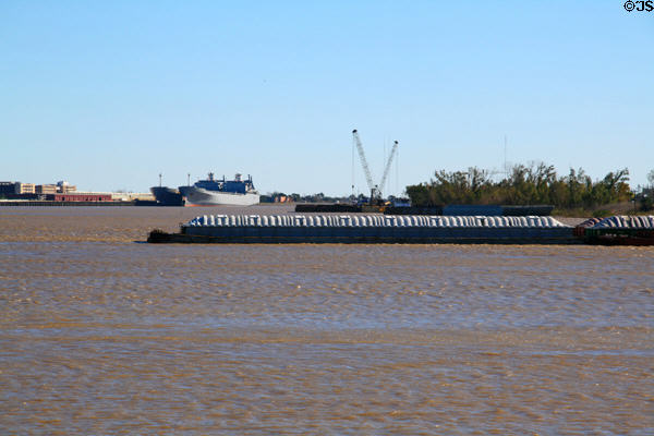 Covered barge rounds Mississippi River at New Orleans. New Orleans, LA.