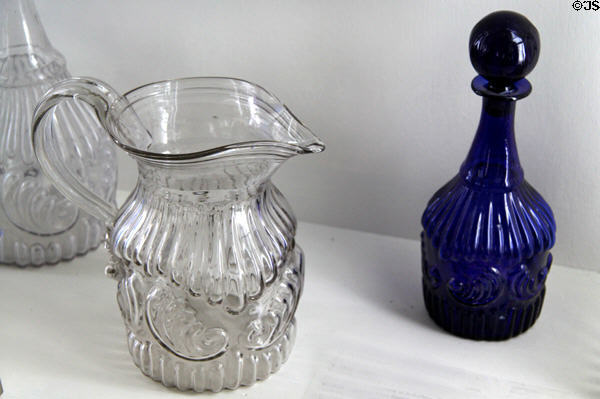 Mold-blown shell & ribbing design glass pitcher & bottles (c1830-40) by Boston & Sandwich Glass Co. at Sandwich Glass Museum. Sandwich, MA.