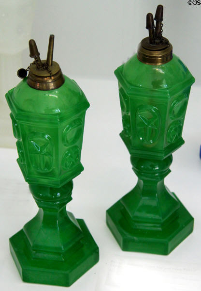 Star & punty pattern green glass kerosene lamps (mid 19thC) at Sandwich Glass Museum. Sandwich, MA.