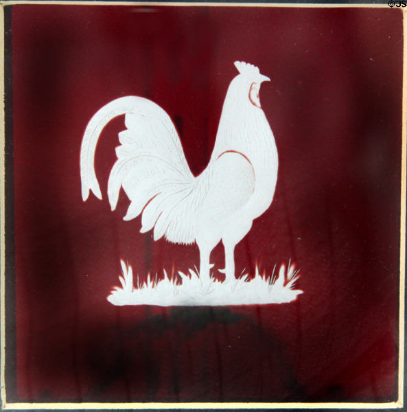 Overlay lantern pane for Lincoln campaign (1860) with rooster emblem of "Wide-Awakes" antislavery political group by Boston & Sandwich Glass Co. at Sandwich Glass Museum. Sandwich, MA.