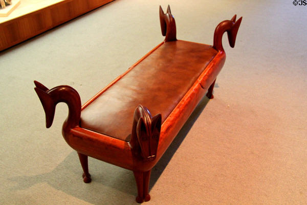 Bench with four animal heads, part of collection of modern chairs for visitor use at Museum of Fine Arts. Boston, MA.