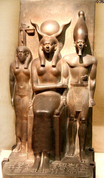 Ancient Egyptian triad statue of King Mycerinus & two gods including Hathor with sun disk & cow's horns (2548-2530 BCE) at Museum of Fine Arts. Boston, MA.