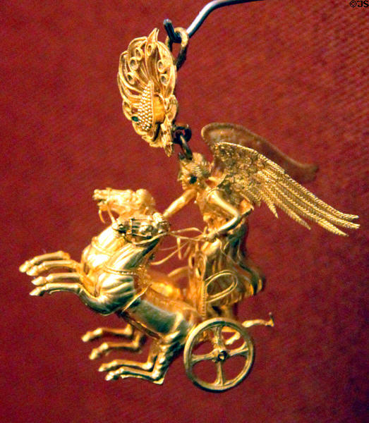 Ancient Greek gold earring of Nike driving her chariot (c325-300 BCE) from Peleponnesos at Museum of Fine Arts. Boston, MA.