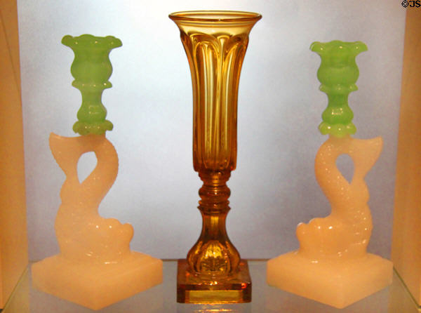 Pressed glass dolphin candlesticks (c1860) by Mount Washington Glass Works & pressed glass vase by Boston & Sandwich Glass Co. at Peabody Essex Museum. Salem, MA.