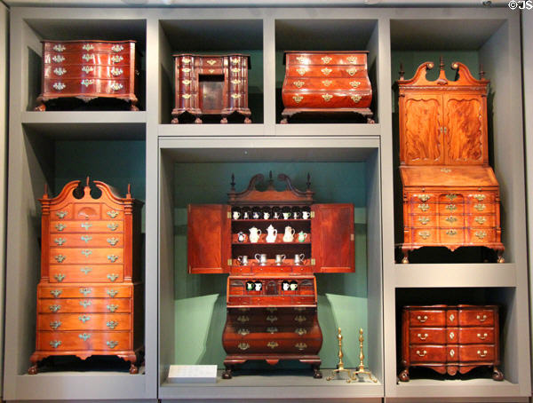 Display of early American chests & desks showing variety of shapes (c1760-1800) mostly from Massachusetts at Museum of Fine Arts. Boston, MA.