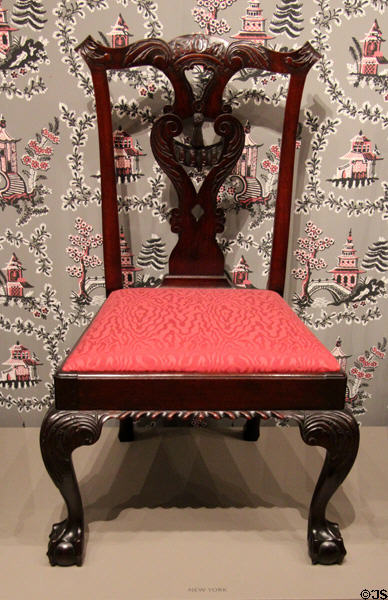 New York chair (c1760) shows gadrooning across front, thick & heavy proportions, square claw & ball foot & carved tassel at Museum of Fine Arts. Boston, MA.