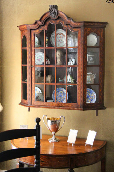 Display cabinet with china over side table at Nichols House Museum. Boston, MA.