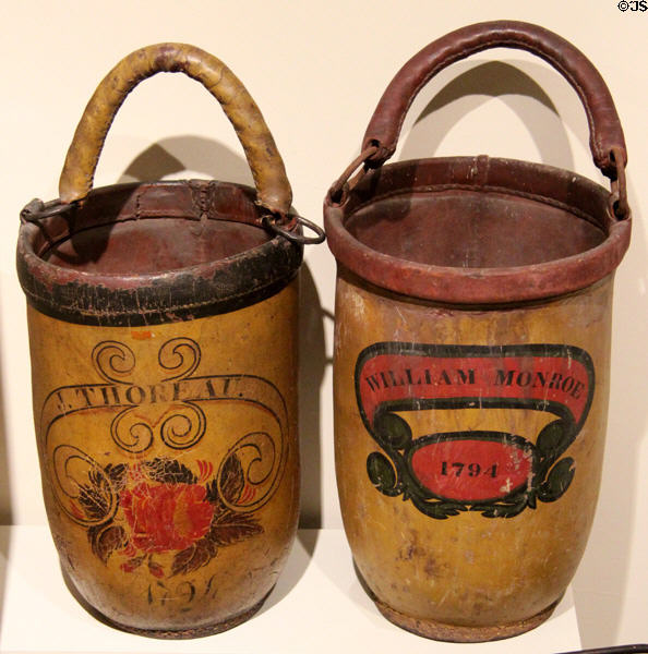 Leather fire buckets (c1825) painted J. Thoreau/1794 & William Monroe/1794 the date the Concord Fire Society was incorporated at Concord Museum. Concord, MA.