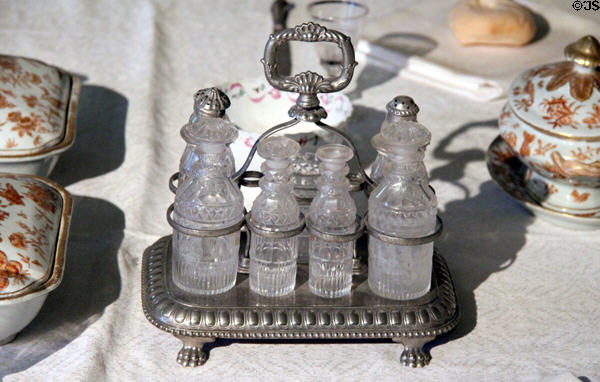 Caster or cruet stand (1810-20) from England with seven bottles at Concord Museum. Concord, MA.