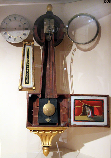 Exploded components display of patent timepiece (aka banjo clock) (c1815-35) by Samuel Whiting et al of Concord since each part made by specialist shops of Concord at Concord Museum. Concord, MA.