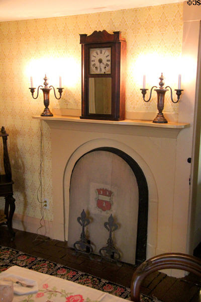 Dining room fireplace with mantle clock at Orchard House. Concord, MA.