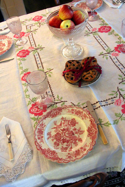Dining room table setting with Coalport china owned by Louisa's mother Abigail May Alcott at Orchard House. Concord, MA.