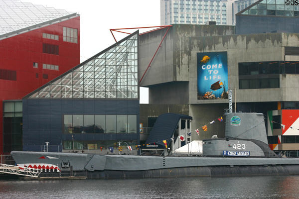 Submarine USS Torsk 423 (1944) at Baltimore Maritime Museum against National Aquarium. Baltimore, MD.