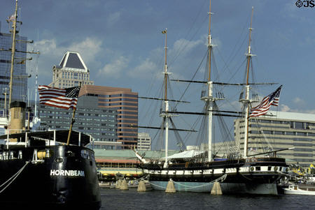 USS Constellation against Baltimore skyline. Baltimore, MD.