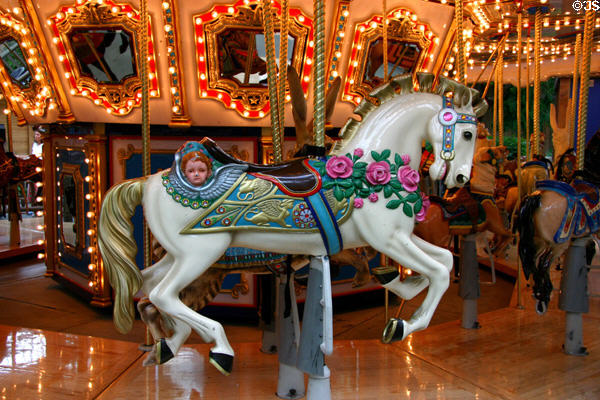 Flower decked white stallion on carousel in Mall of America. Minneapolis, MN.