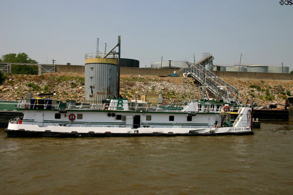 Mississippi River barge with storage tanks beyond. St Louis, MO.