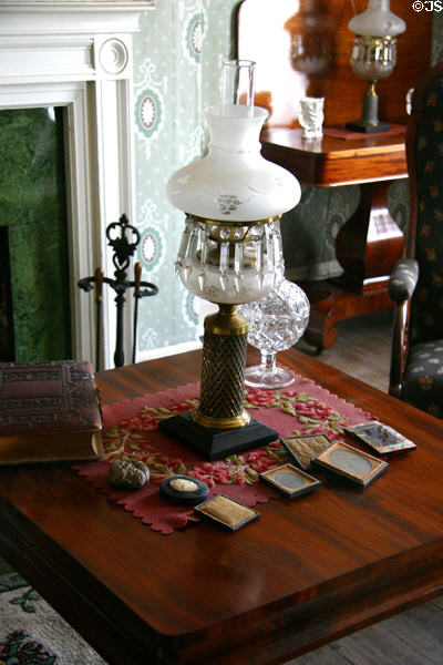 Becky Thatcher House parlor table & oil lamp at Mark Twain Boyhood Home & Museum. Hannibal, MO.