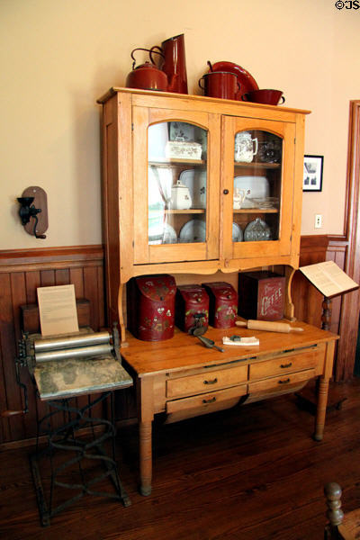 Kitchen cabinet beside beaten biscuit rolling machine at Vaile Mansion. Independence, MO.