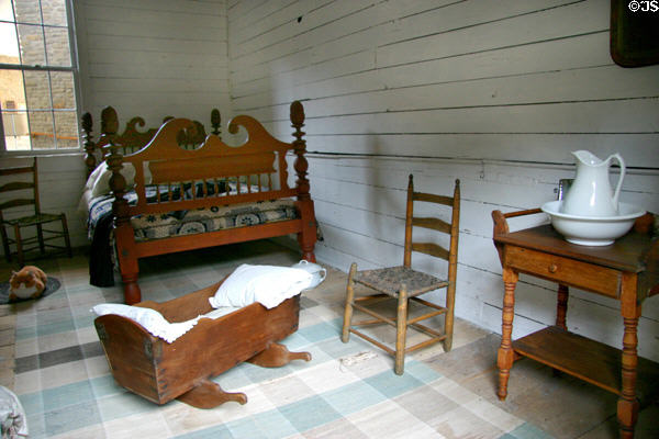Bed, cradle, ladder-back chair & wash stand in Mark Twain birthplace cabin at Mark Twain Memorial Shrine. MO.