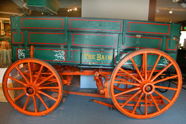 Painted horse-drawn freight wagon lettered The Bain at Museum of the Rockies. Bozeman, MT.