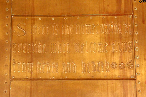 Bedroom fireplace with copper repousse slogan 'Sweet is the homecoming at eventide when welcome glows from heart and hearth ' at Craftsman Farms. Morris Plains, NJ.