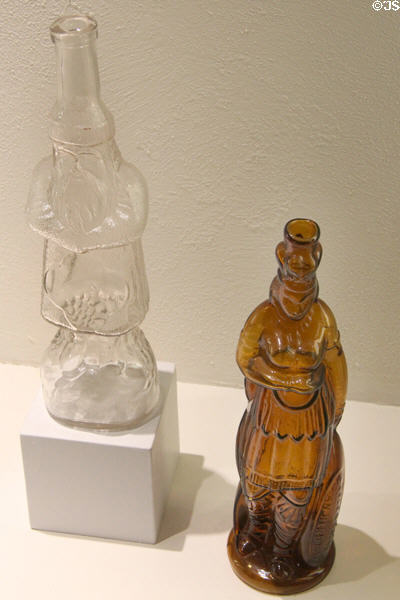Figural bottle by Cumberland Glass Works of Bridgeton, NJ & Brown's Celebrated Indian herb Bitters bottle (1868) attrib. Whitney Glass Works of Glassboro, NJ at Museum of American Glass. Milville, NJ.