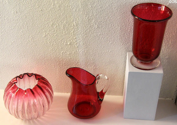 Ruby colored glass bowl, pitcher, spooner (1900-20) by Emil Stanger for Whitall Tatum Co. of Millville, NJ at Museum of American Glass. Milville, NJ.