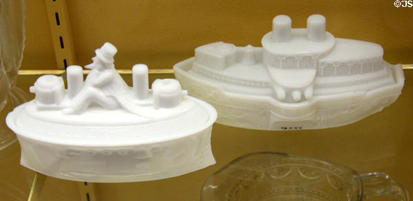 Pressed milk glass models of Uncle Sam on a battleship (c1898) by Flaccus Brothers Co. of Wheeling, WV & Battleship Maine (c1890) by unknown both related to Spanish American War at Museum of American Glass. Milville, NJ.