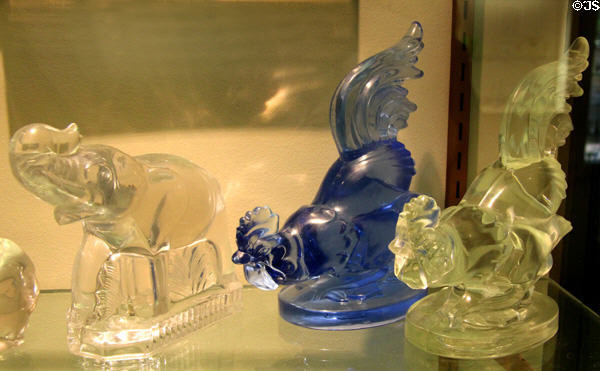 Elephant glass bookend (c1939) by Fostoria Glass Co., Moundsville, WV & rooster figures (early 1940s) by Barth Art Glass Co. of NEW Martinsville, WV at Museum of American Glass. Milville, NJ.
