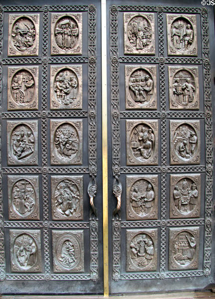 Bronze doors (1986) shows scenes of local history by Donna Quasthoff at St. Francis Cathedral. Santa Fe, NM.