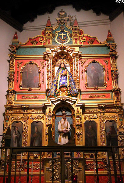 La Conquistadora Chapel (1626) with Our Lady of the Rosary (1626) on reredos with saints in St. Francis Cathedral. Santa Fe, NM.